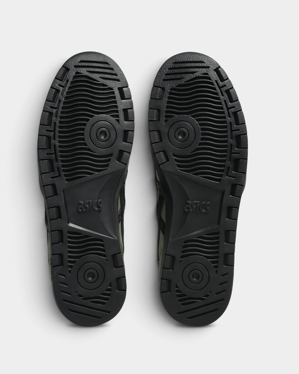 Asics Skateboarding Japan Pro Shoes in Moss/Black, outsoles of the pair: black rubber with a flat tread, circular pivot patterns and an ASICS logo