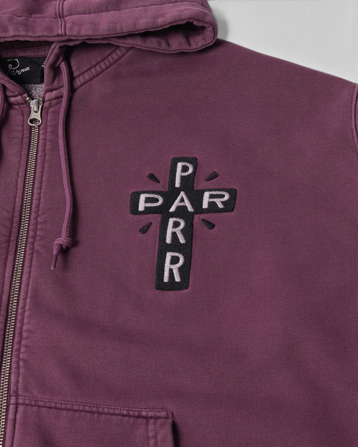 by Parra A Cross to Bear Zip Hooded Sweatshirt - Purple, close-up of the chest embroidery, zip and drawcord