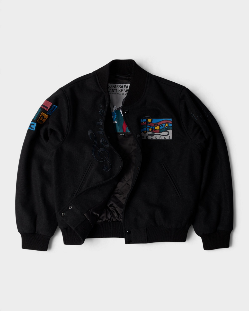 by Parra All the Best Varsity Jacket - Black, opened up, showing the quilted lining