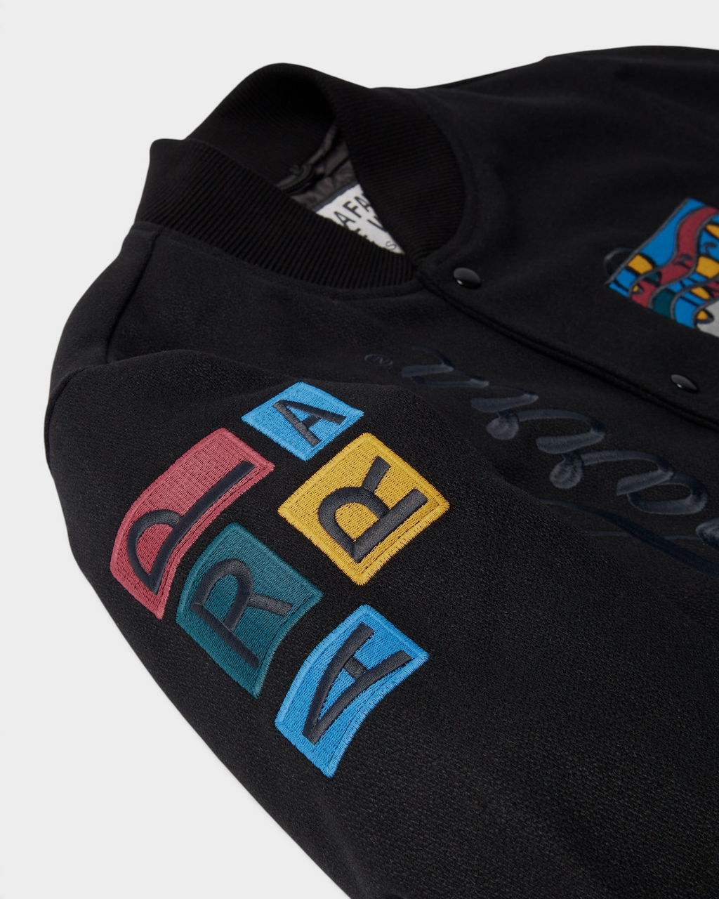 by Parra All the Best Varsity Jacket - Black, close-up of the PARRA letter patches on the sleeve