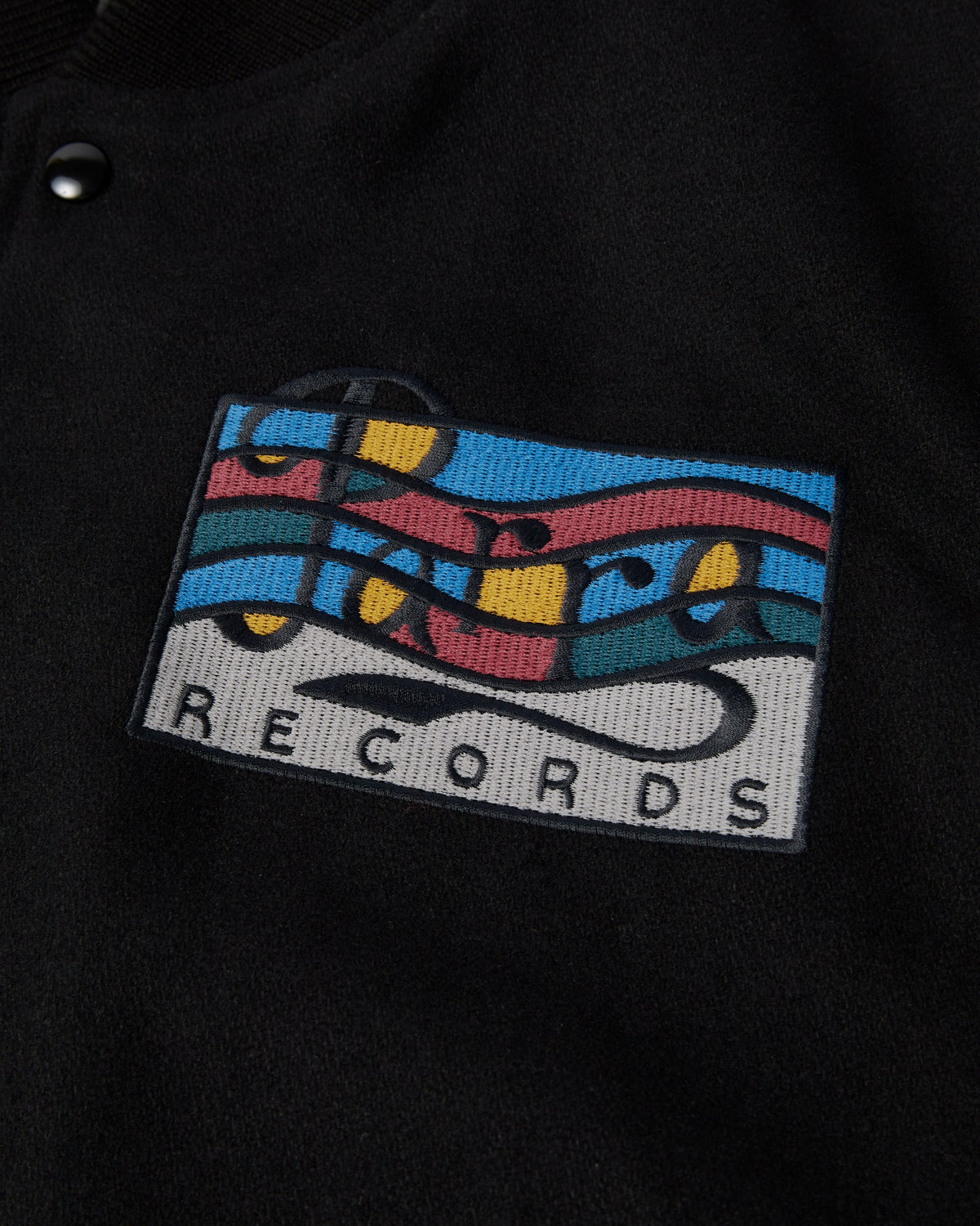by Parra All the Best Varsity Jacket - Black, close-up of the Parra Records patch