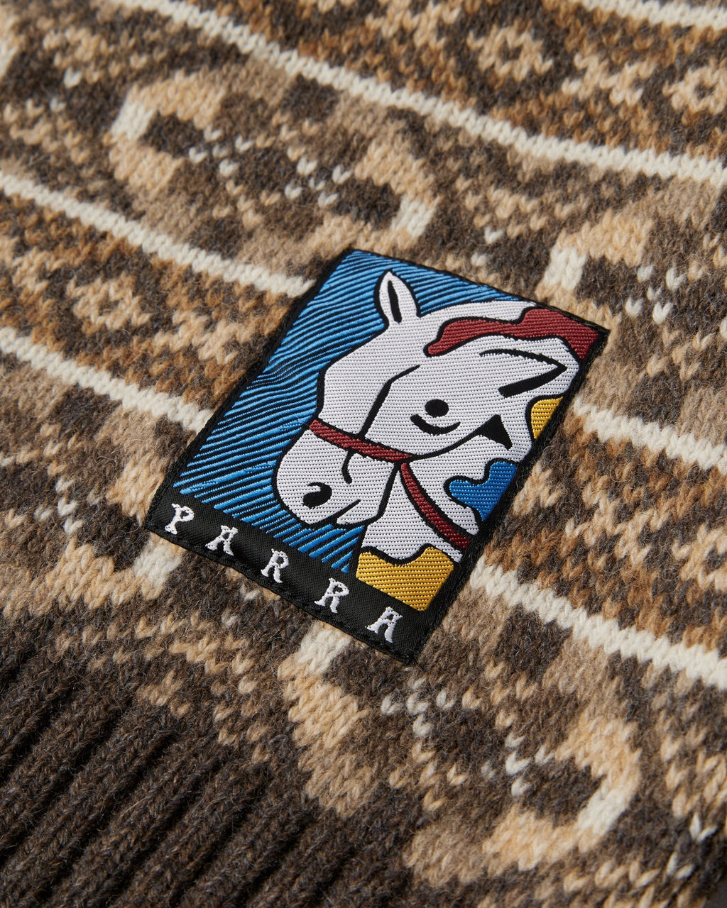 by Parra Cactus Bull Knitted Pullover - Brown, close-up of the Parra horse patch at the hem
