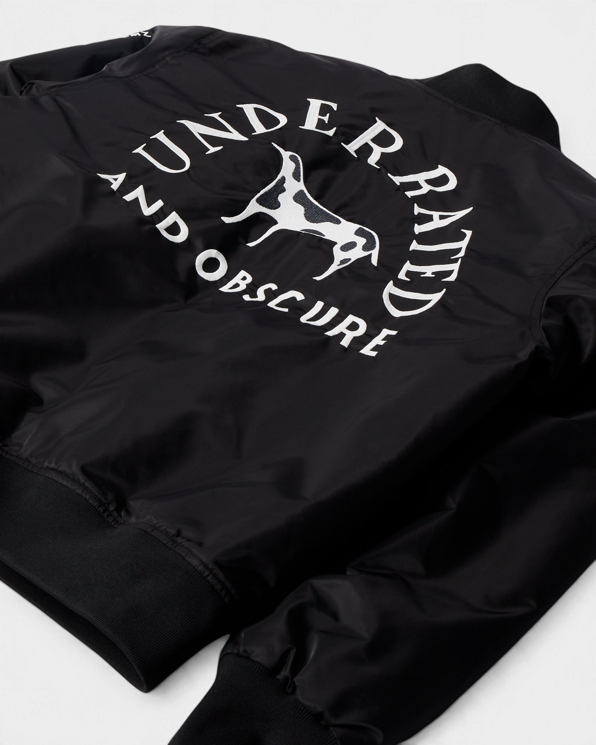 by Parra Club Not 1976 Satin Bomber Jacket - Black, close-up of the back embroidery