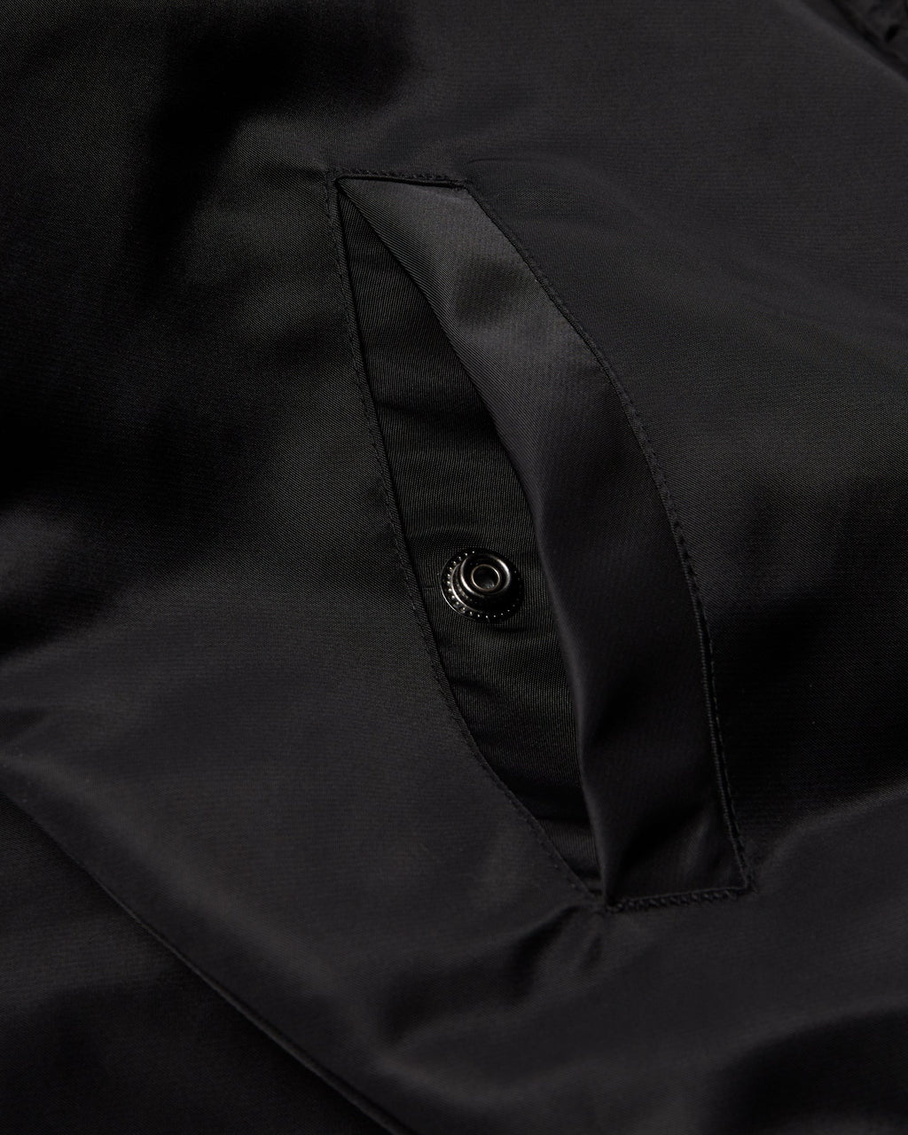 by Parra Club Not 1976 Satin Bomber Jacket - Black, close-up of a side pocket