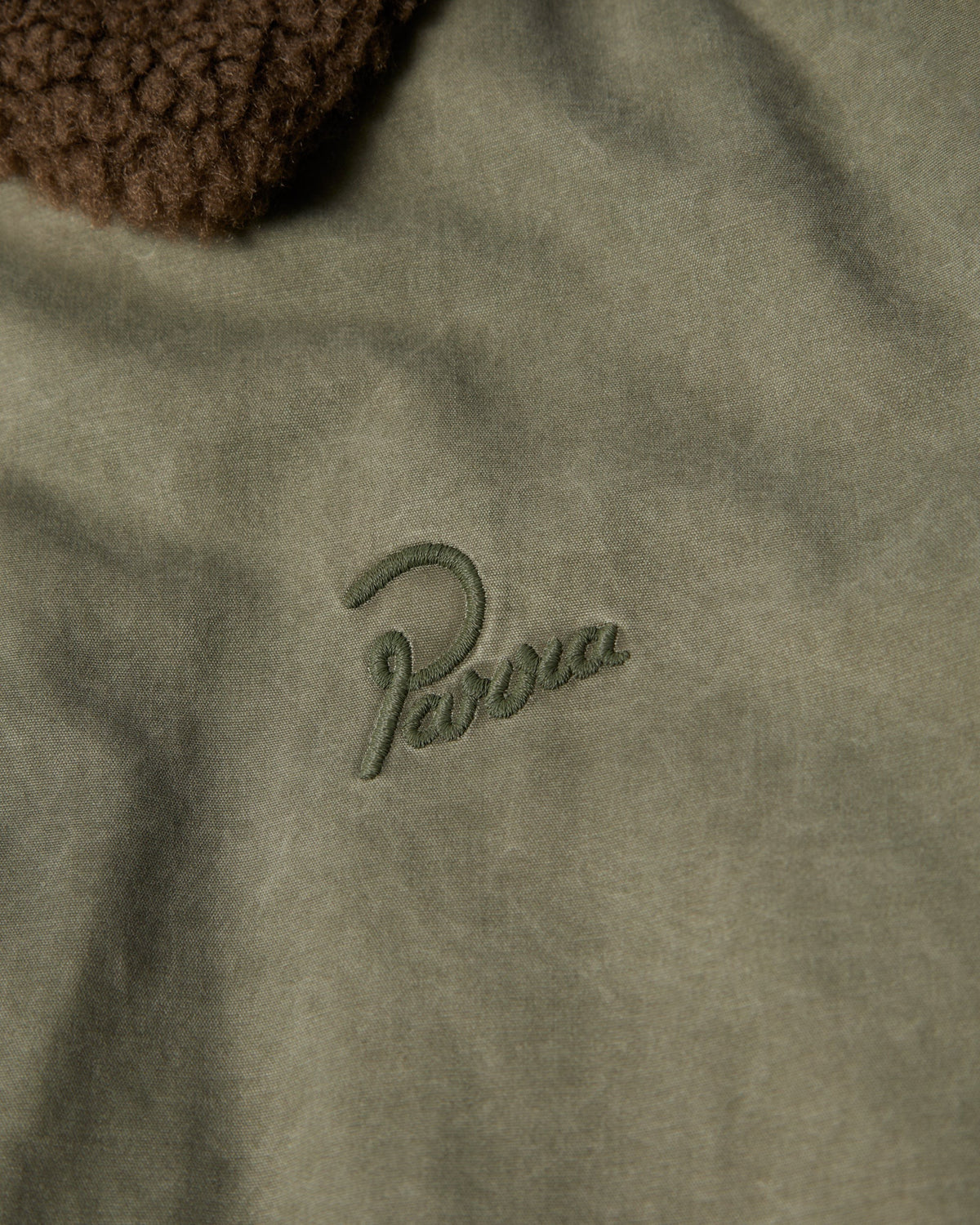 by Parra Darwin Takes Flight Jacket - Green, close-up of the embroidered Parra chest logo