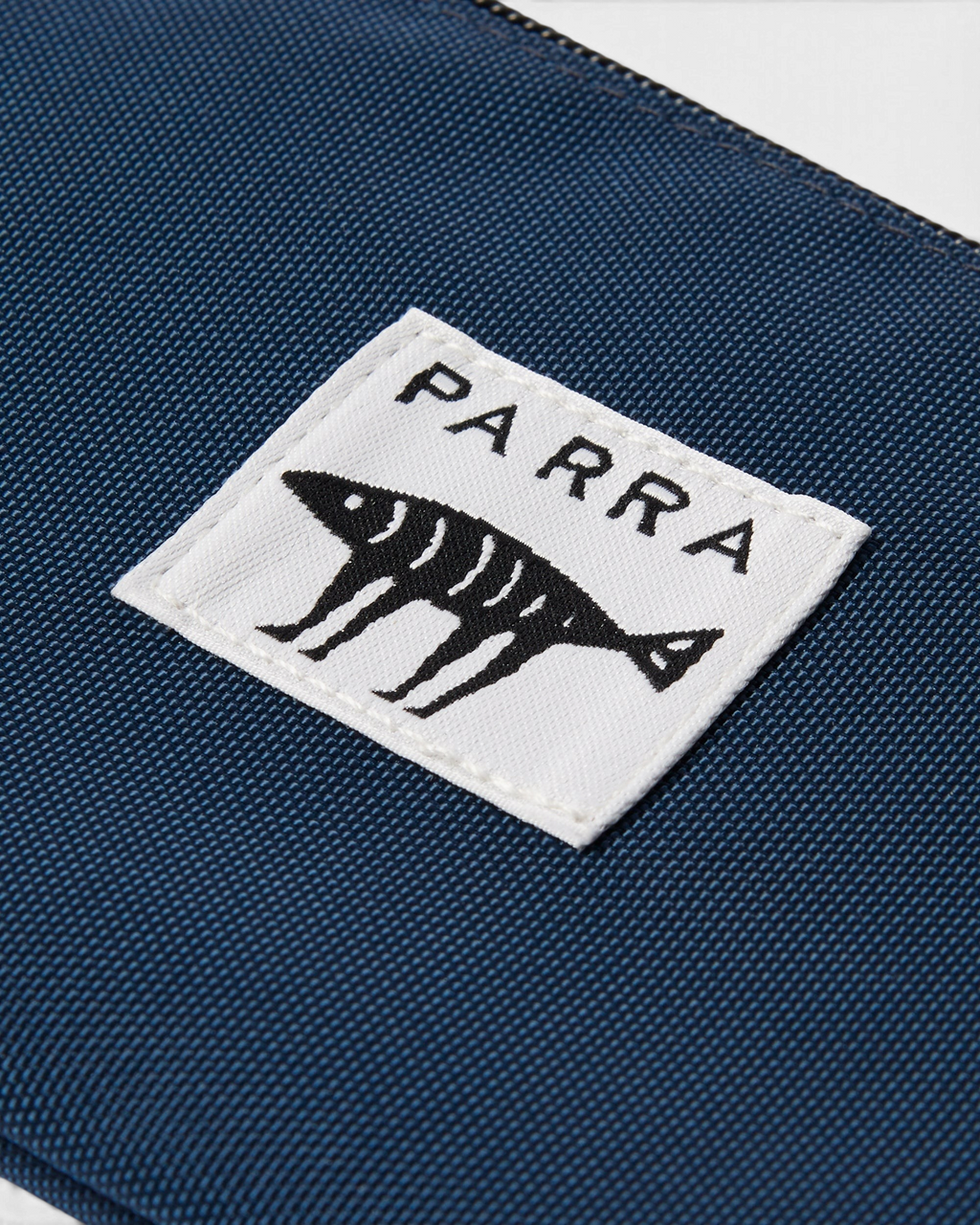 by Parra Money Darwin Pouch Wallet - Blue, close-up of the woven Parra label