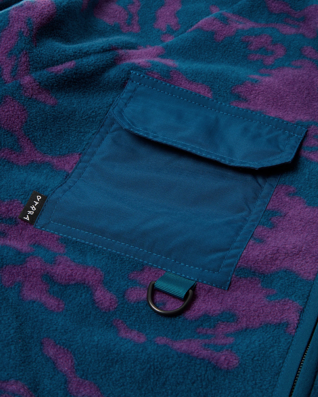 by Parra Purple Darwin Camo Fleece - Blue, close-up of a chest pocket with its D-ring