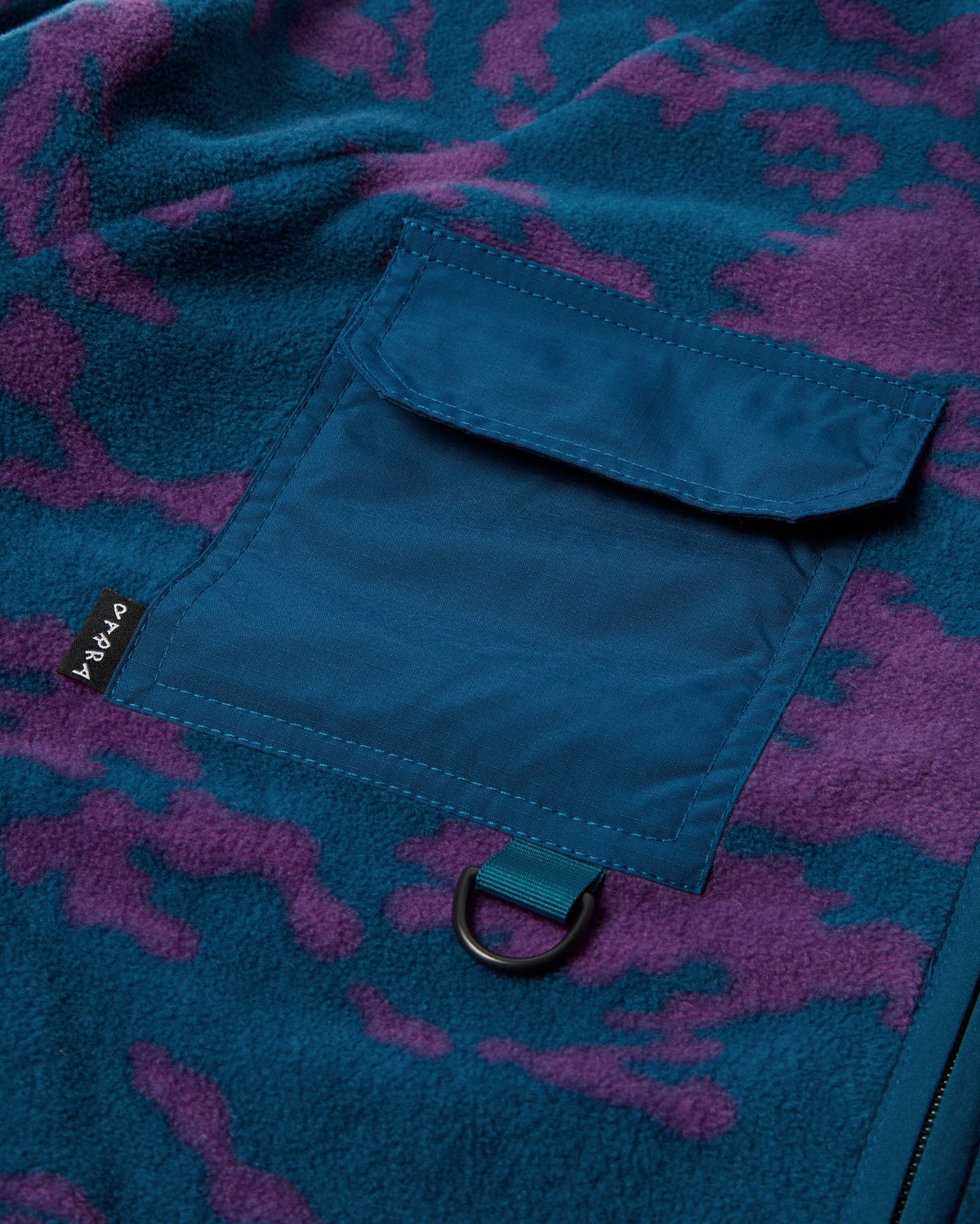 by Parra Purple Darwin Camo Fleece - Blue, close-up of a chest pocket with its D-ring