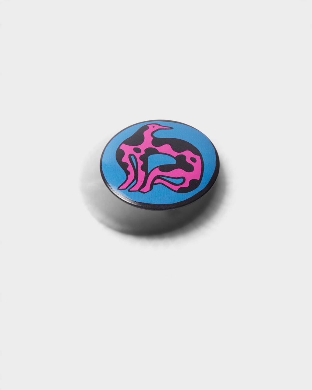by Parra Some Butonis Pin-Back Set - Pink, close-up of the blue button with a pink figure