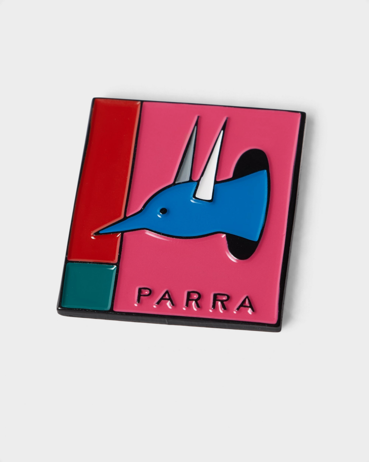 by Parra The Hunted Enamel Pin - Pink, close-up of the enamel pin, a blue horned head on pink with PARRA below