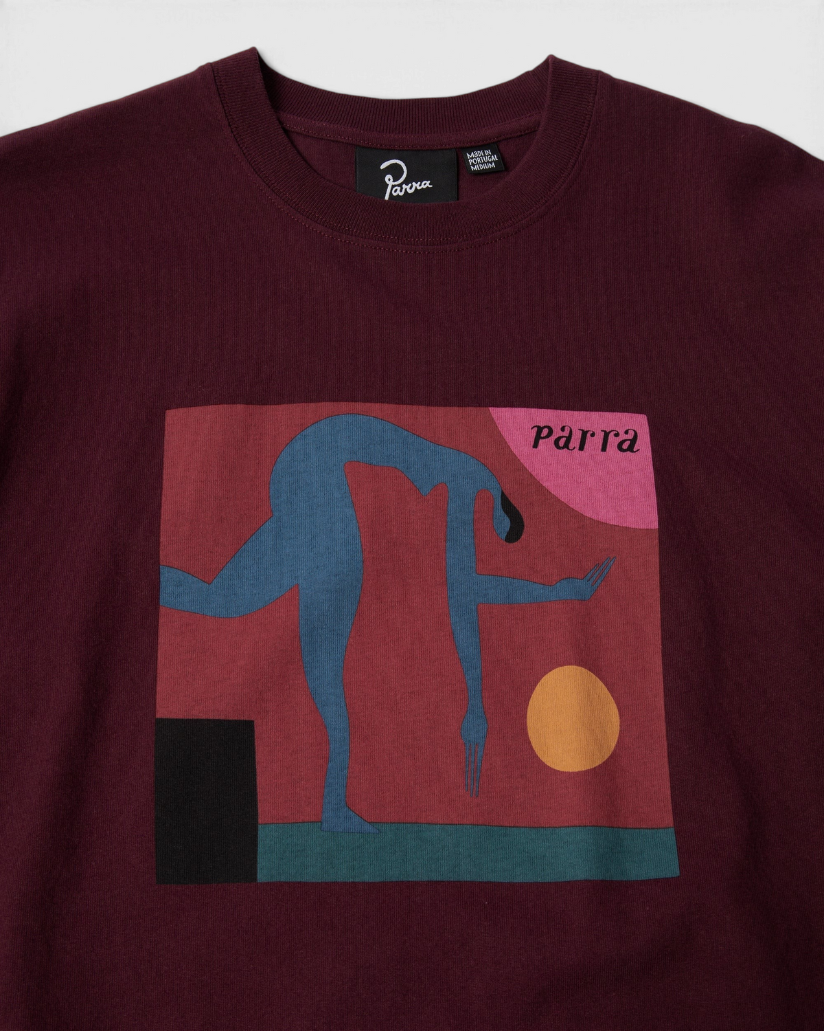 by Parra Tripped Up T-Shirt - Dark Red, close-up of the front print and the Parra neck label