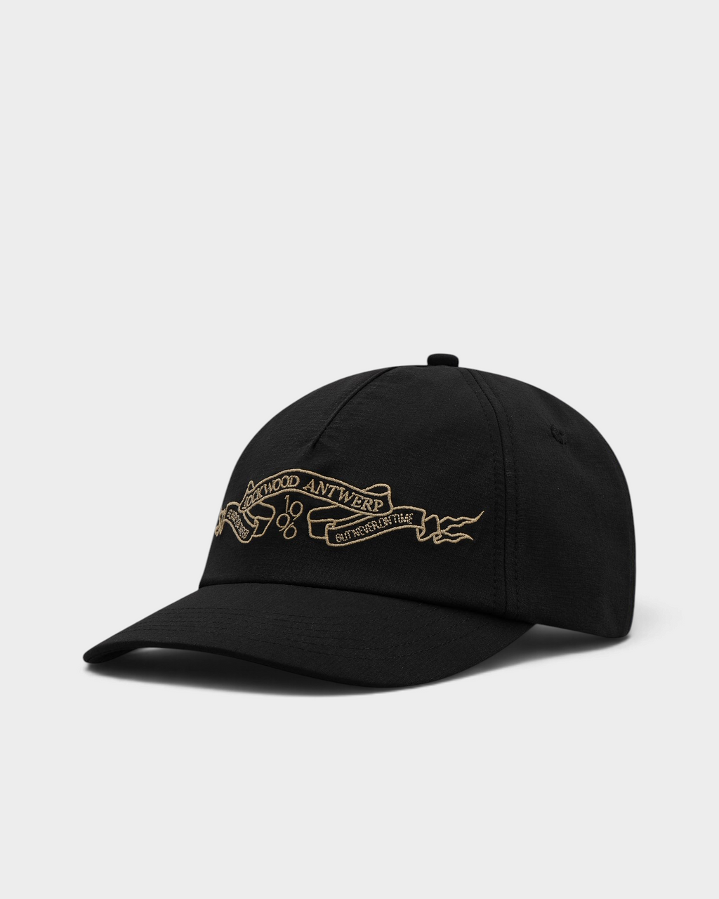 Lockwood Ribbon Cap in Black, side view showing the curved brim and the embroidered ribbon banner