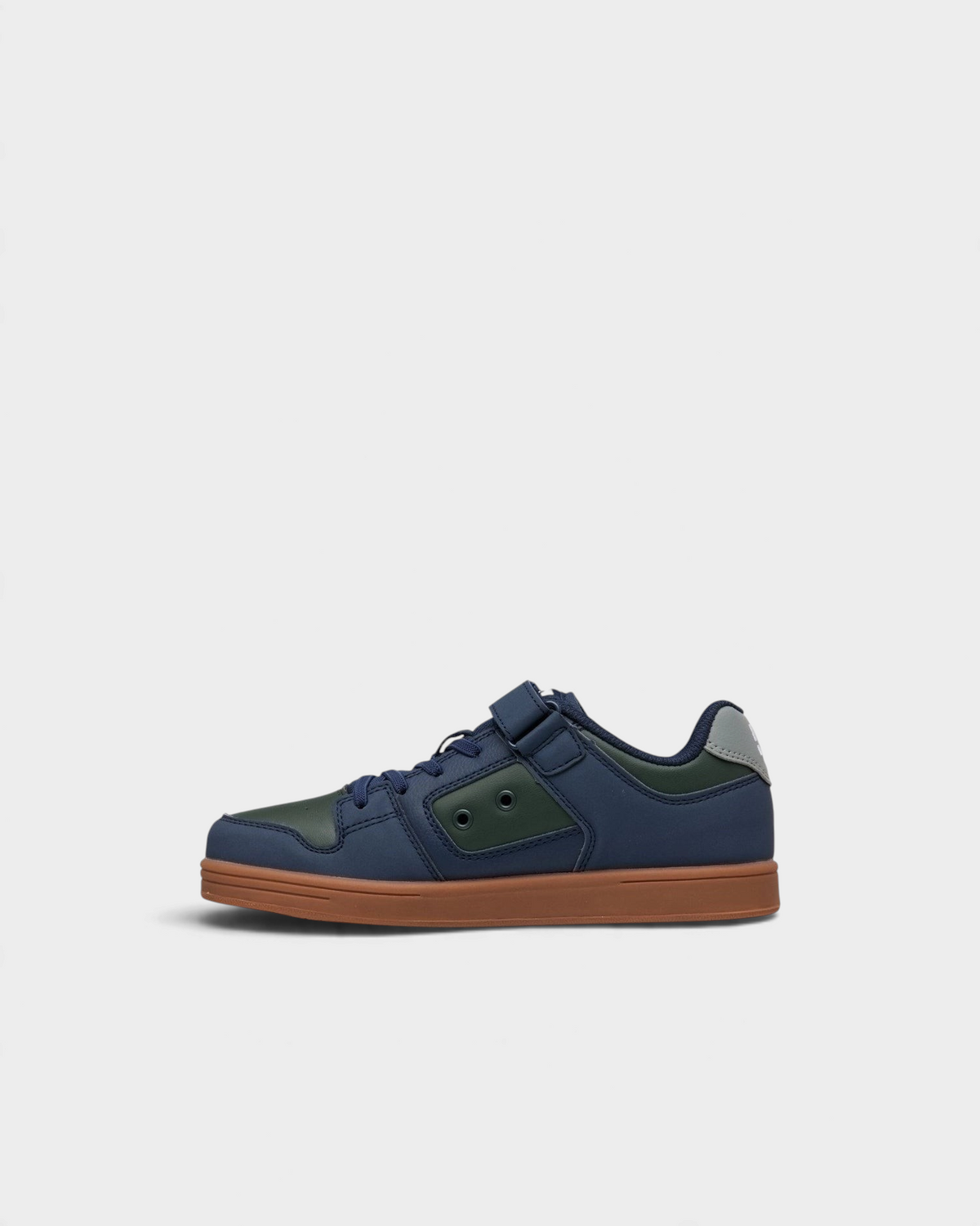 Lockwood Avenue DC Manteca 4 kids skate shoes in navy and green, inner side view showing the green eyelet panel and grey heel tab