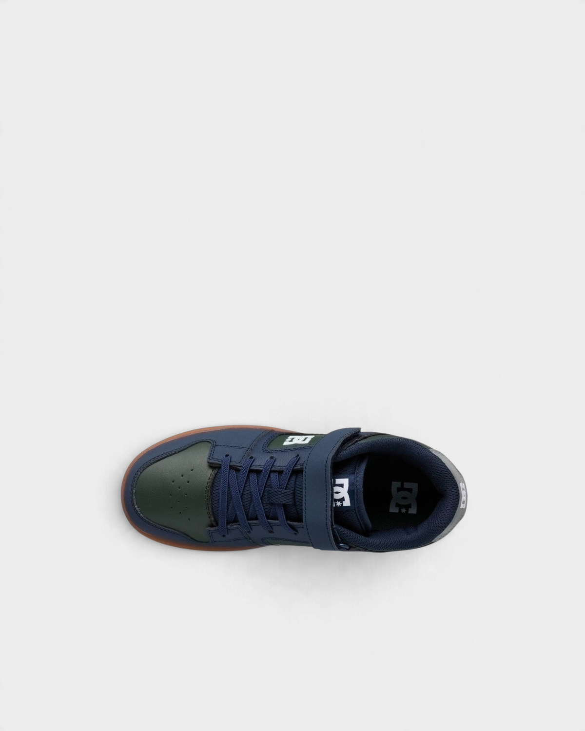 Lockwood Avenue DC Manteca 4 kids skate shoes in navy and green seen from above, with the padded navy collar and DC logo on the insole