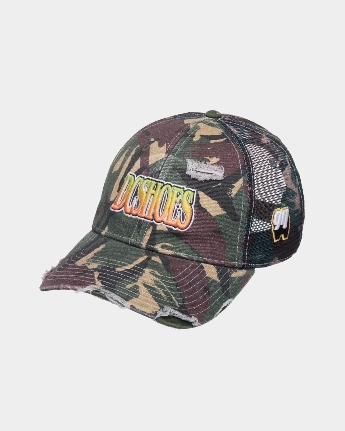 DC Shoes Fish On Cap in Classic Camo, three-quarter front view of the green and brown camo trucker showing DCSHOES embroidered in a yellow to orange gradient script, a small white 94 patch on the mesh side panel and a frayed distressed bill