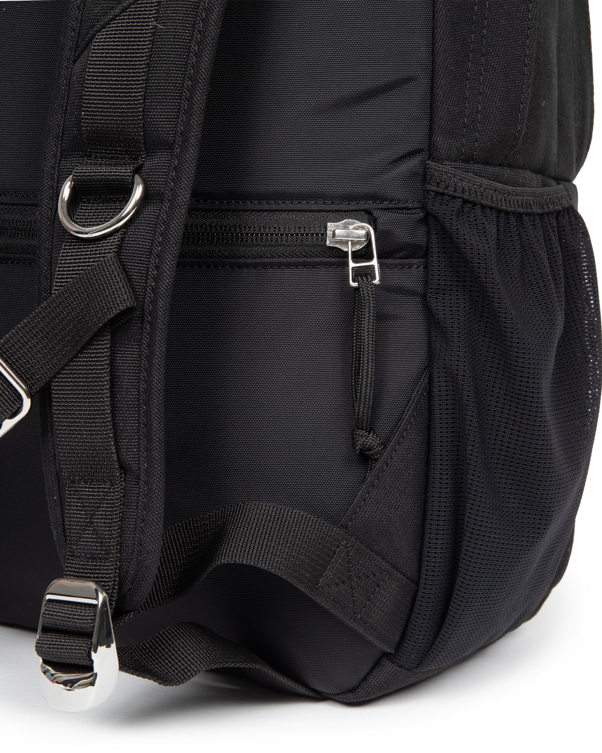 Close up of the lower side of the Eastpak x Dime Getter Backpack in Dime Black, showing the zipped side pocket and the webbing strap running into the mesh pocket