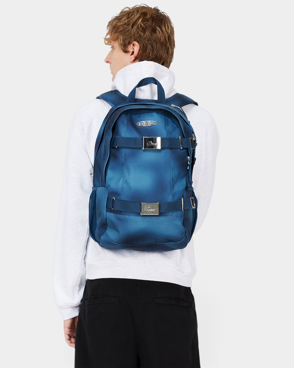 Eastpak x Dime Getter Backpack in Dime Navy worn on the back, seen from the side