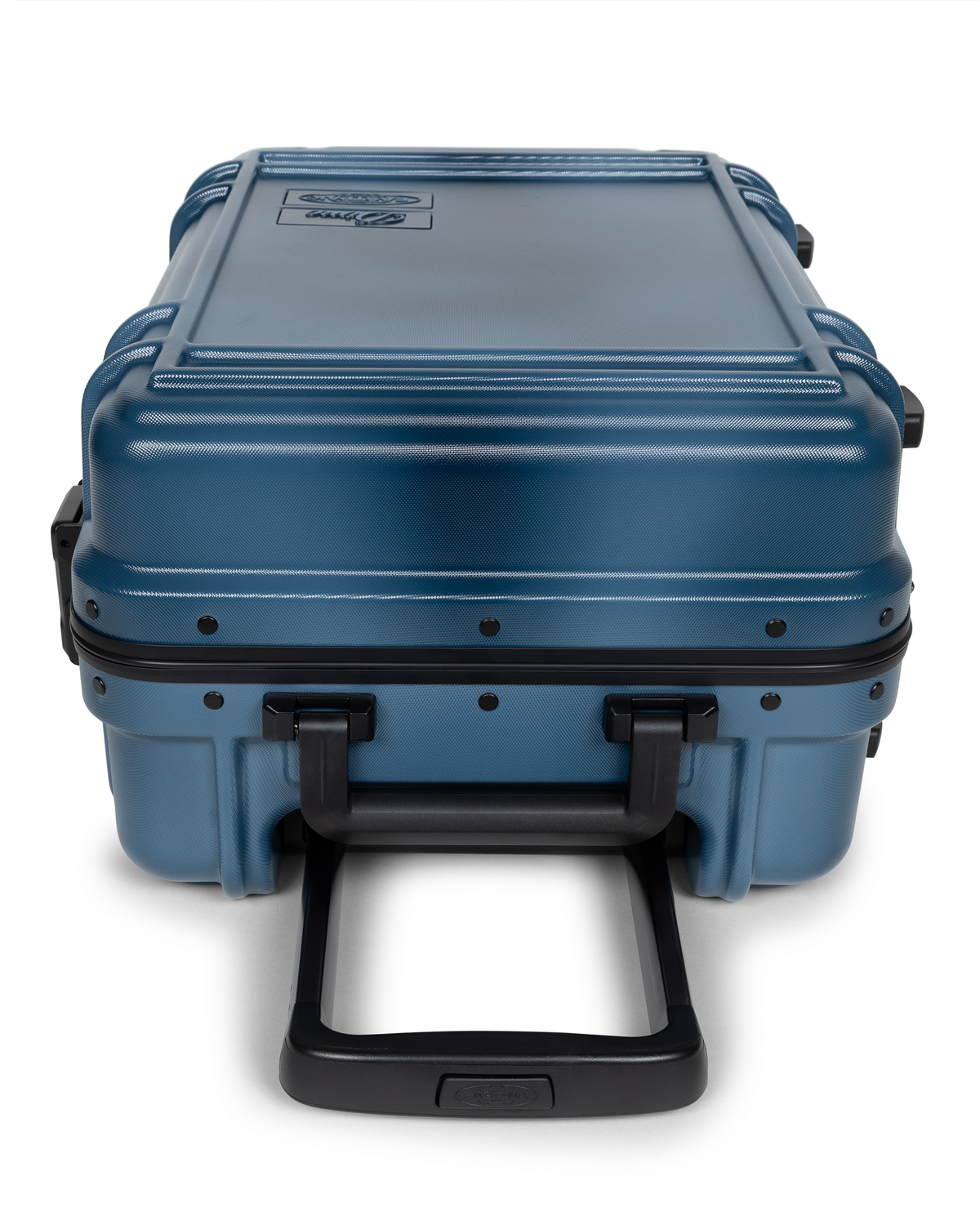 Eastpak x Dime Resist'R Case S in Dime Navy laid on its back with the telescopic handle extended toward the camera, showing the riveted frame, the ribbed top panel and the moulded top and side grab handles
