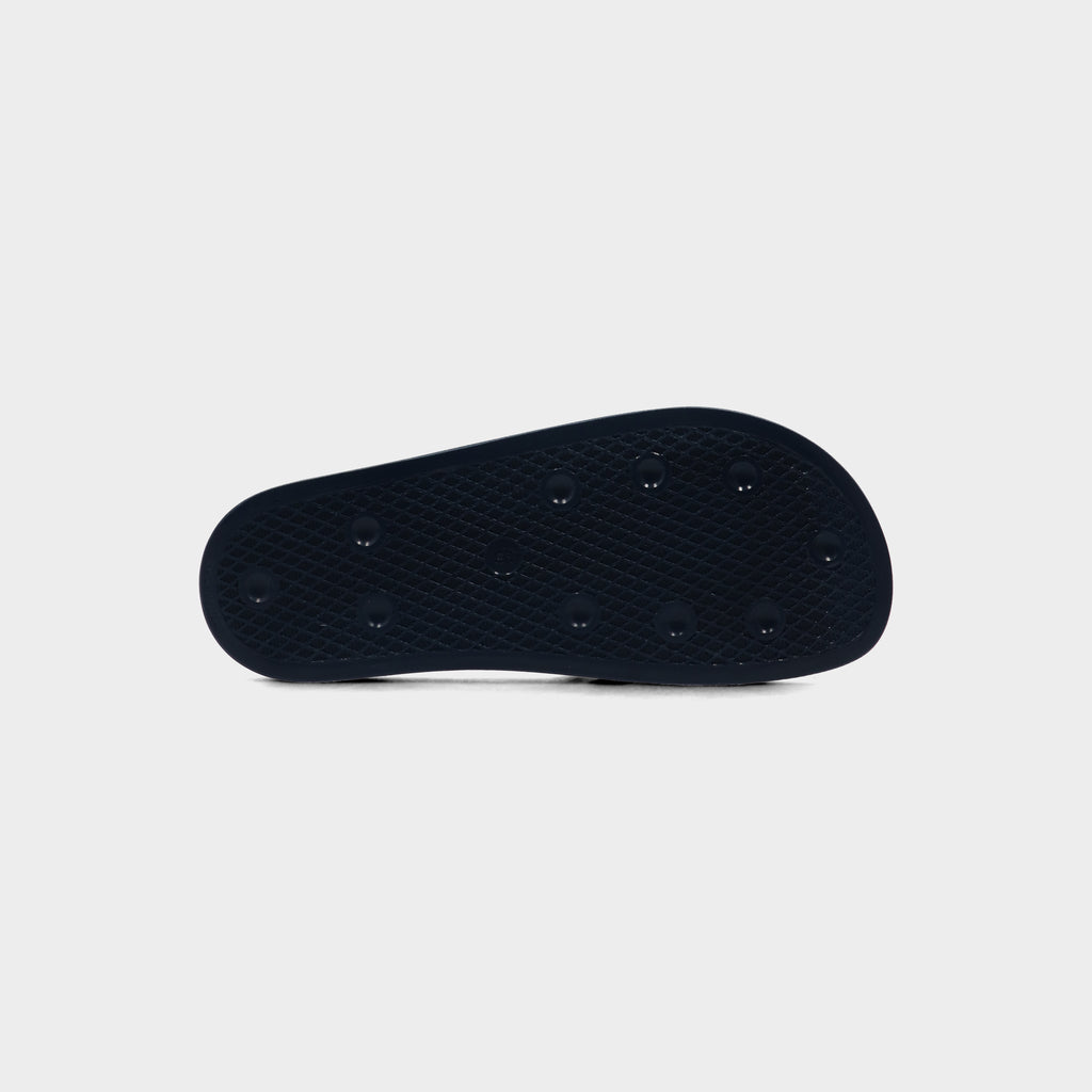 Lockwood Avenue adidas Adilette Slide in AdiBlu navy, view of the textured outsole
