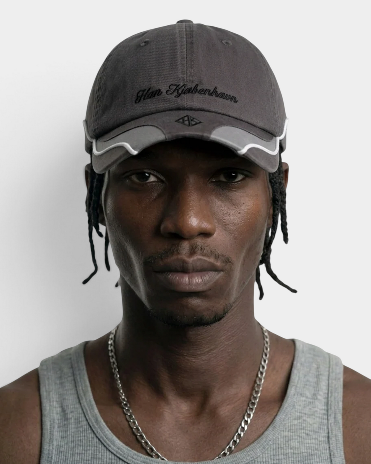Han Kjøbenhavn Retro Cap in Stone Grey worn, a head-and-shoulders shot showing the structured high-profile crown sitting up off the head
