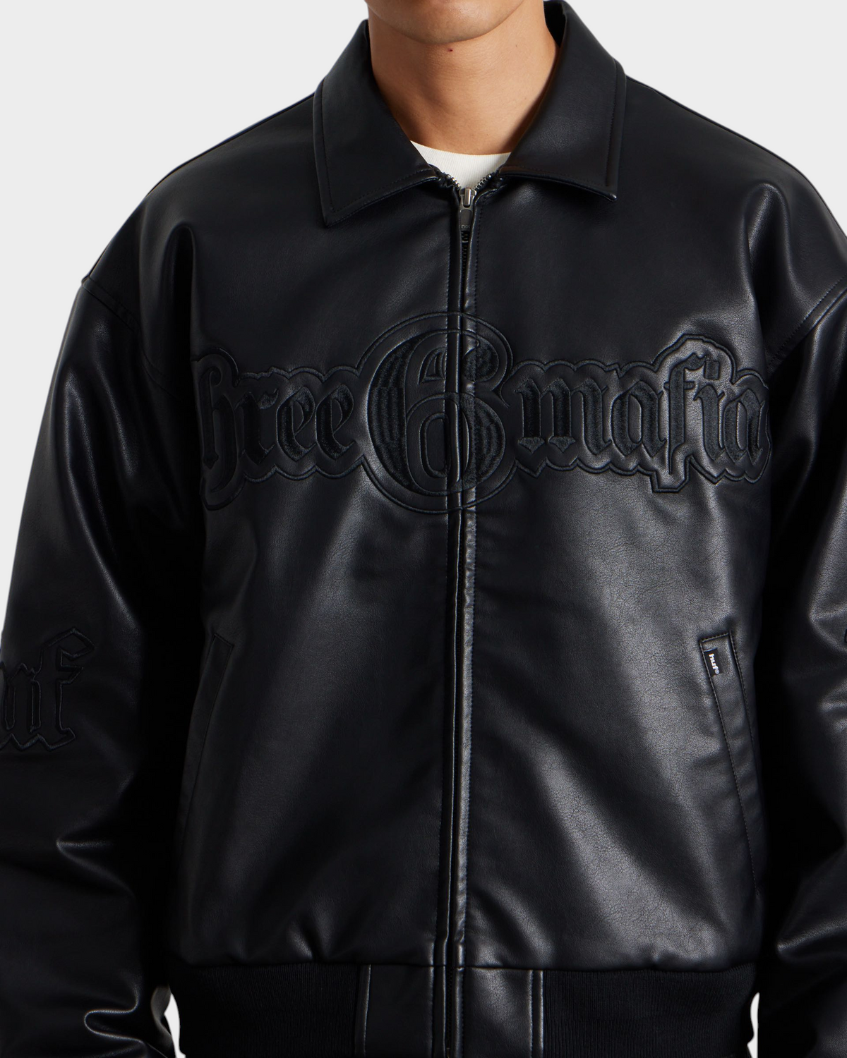 HUF x Three 6 Mafia Jacket - Black, worn by a model, close-up of the collar and chest