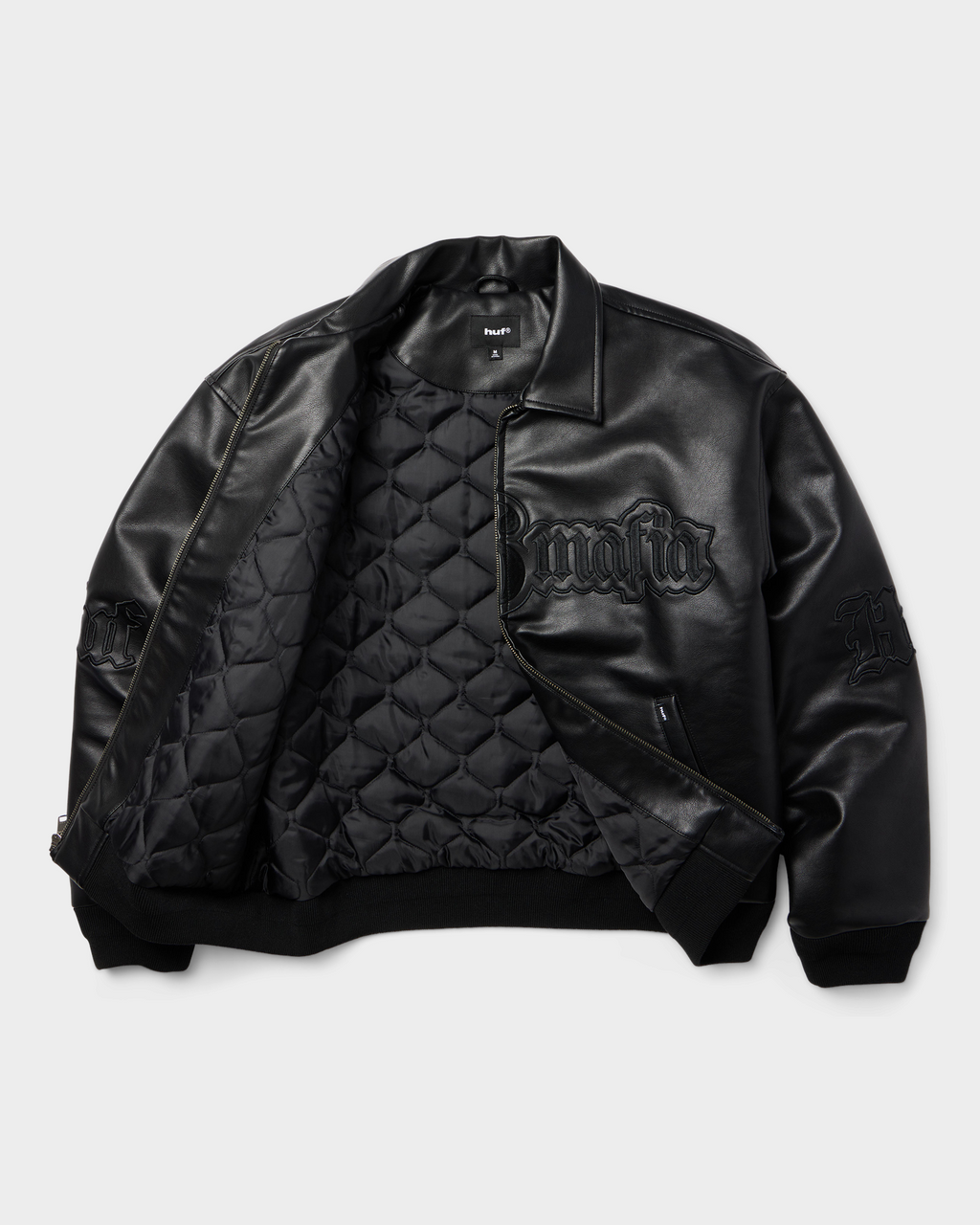 HUF x Three 6 Mafia Jacket - Black, open flat-lay showing the quilted lining