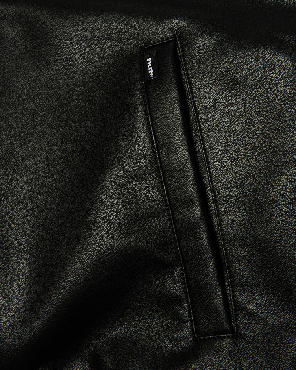 HUF x Three 6 Mafia Jacket - Black, close-up of a welt pocket with its woven label
