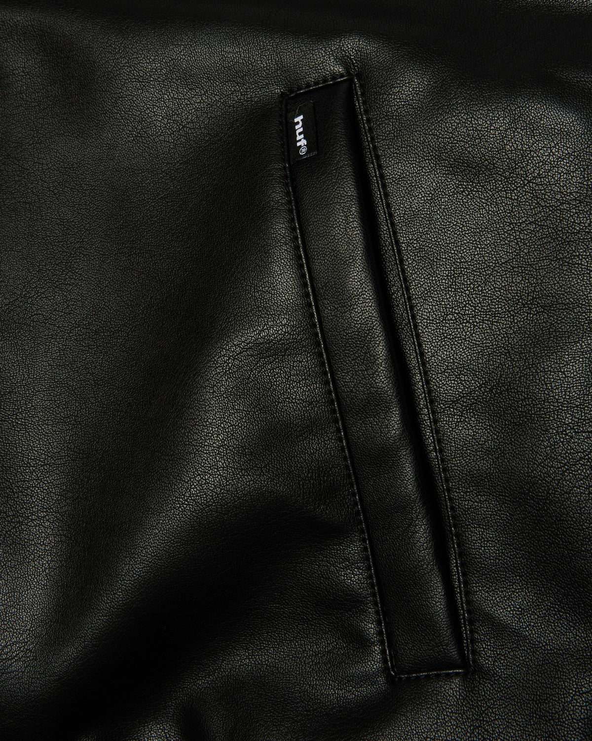 HUF x Three 6 Mafia Jacket - Black, close-up of a welt pocket with its woven label