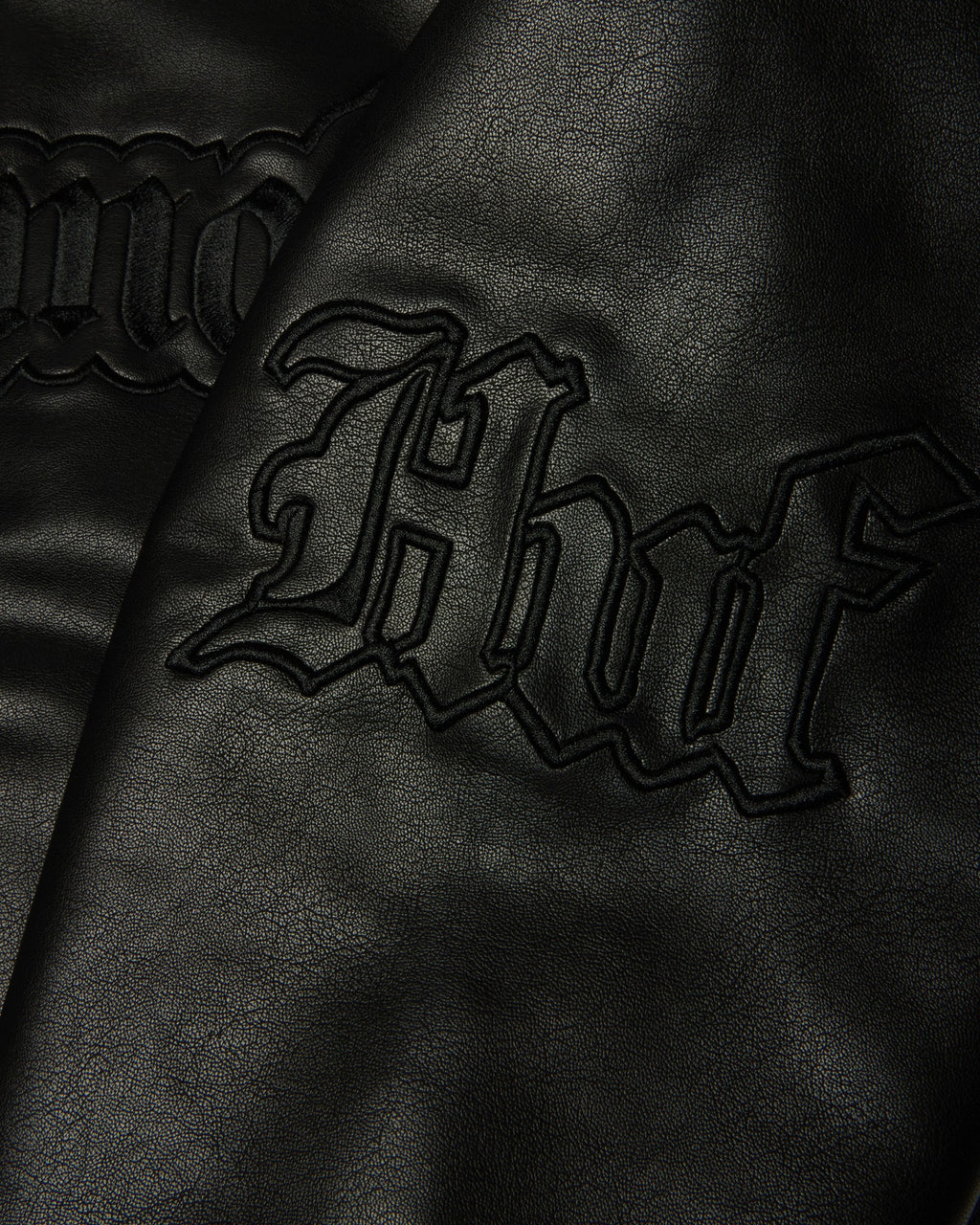 HUF x Three 6 Mafia Jacket - Black, close-up of the embroidered huf on the sleeve