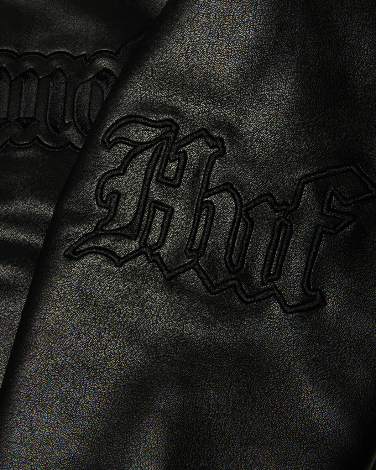 HUF x Three 6 Mafia Jacket - Black, close-up of the embroidered huf on the sleeve