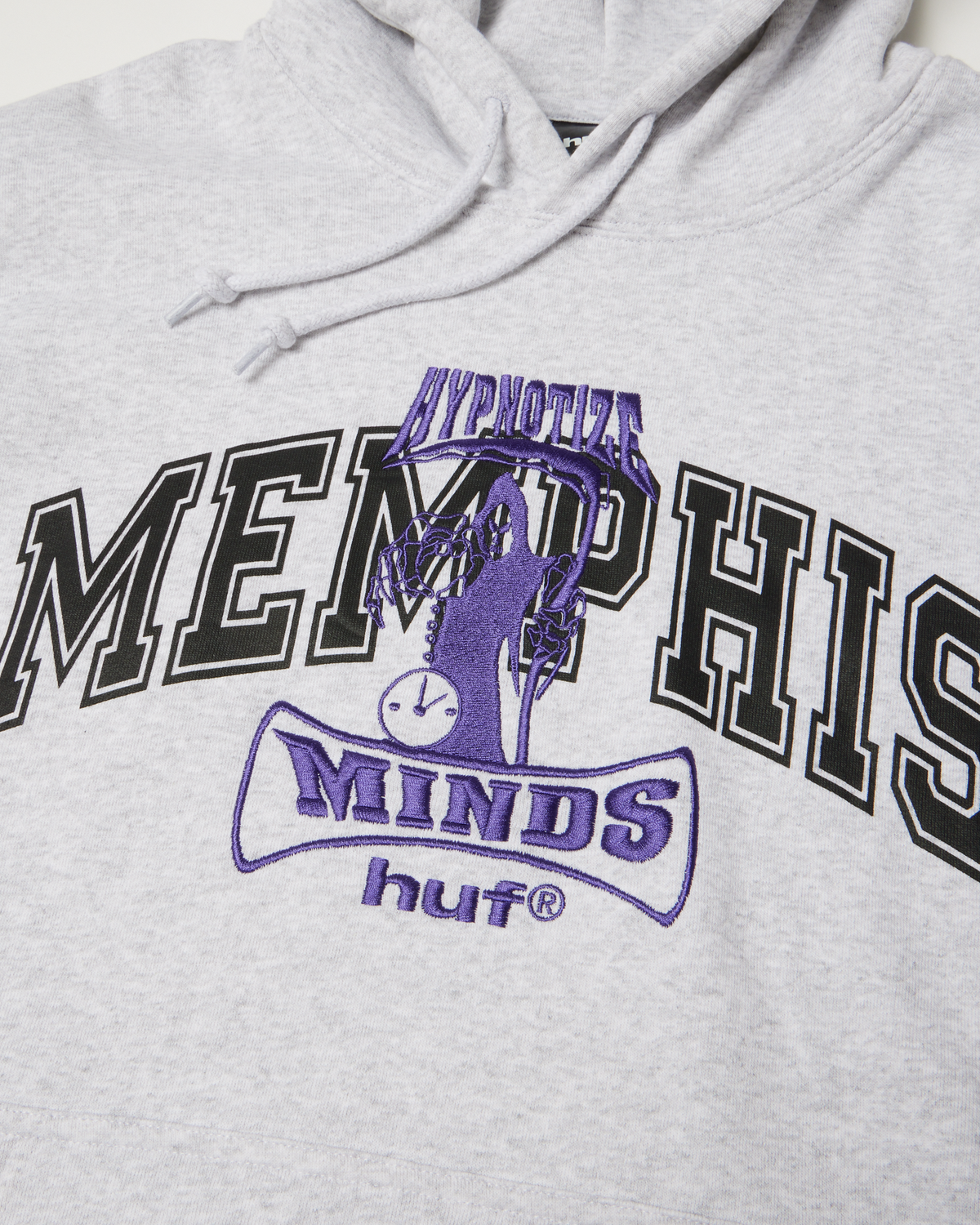HUF x Three 6 Mafia Memphis Pullover Hoodie - Heather Grey, close-up of the printed and embroidered Memphis logo with the hood drawcords