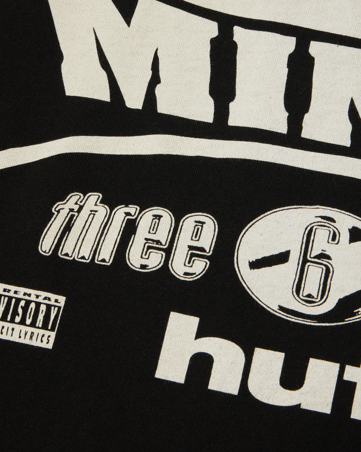 HUF x Three 6 Mafia Most Known Unknown T-Shirt - Washed Black, close-up of the back logos and parental advisory label