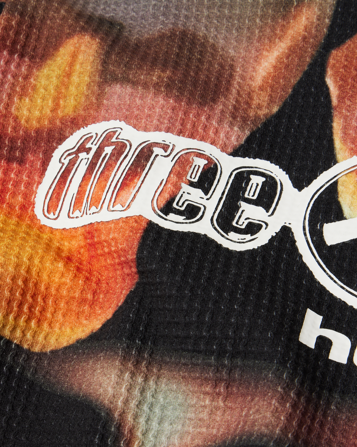 HUF x Three 6 Mafia Torched Long-Sleeve Thermal Shirt - Multi, close-up of the three 6 print on the waffle knit