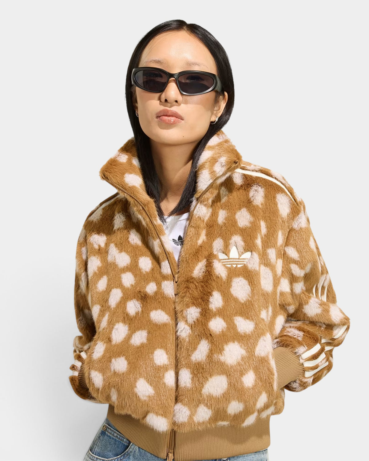 Lockwood Avenue model wearing a brown animal print faux-fur adidas Firebird track jacket with white 3-Stripes.