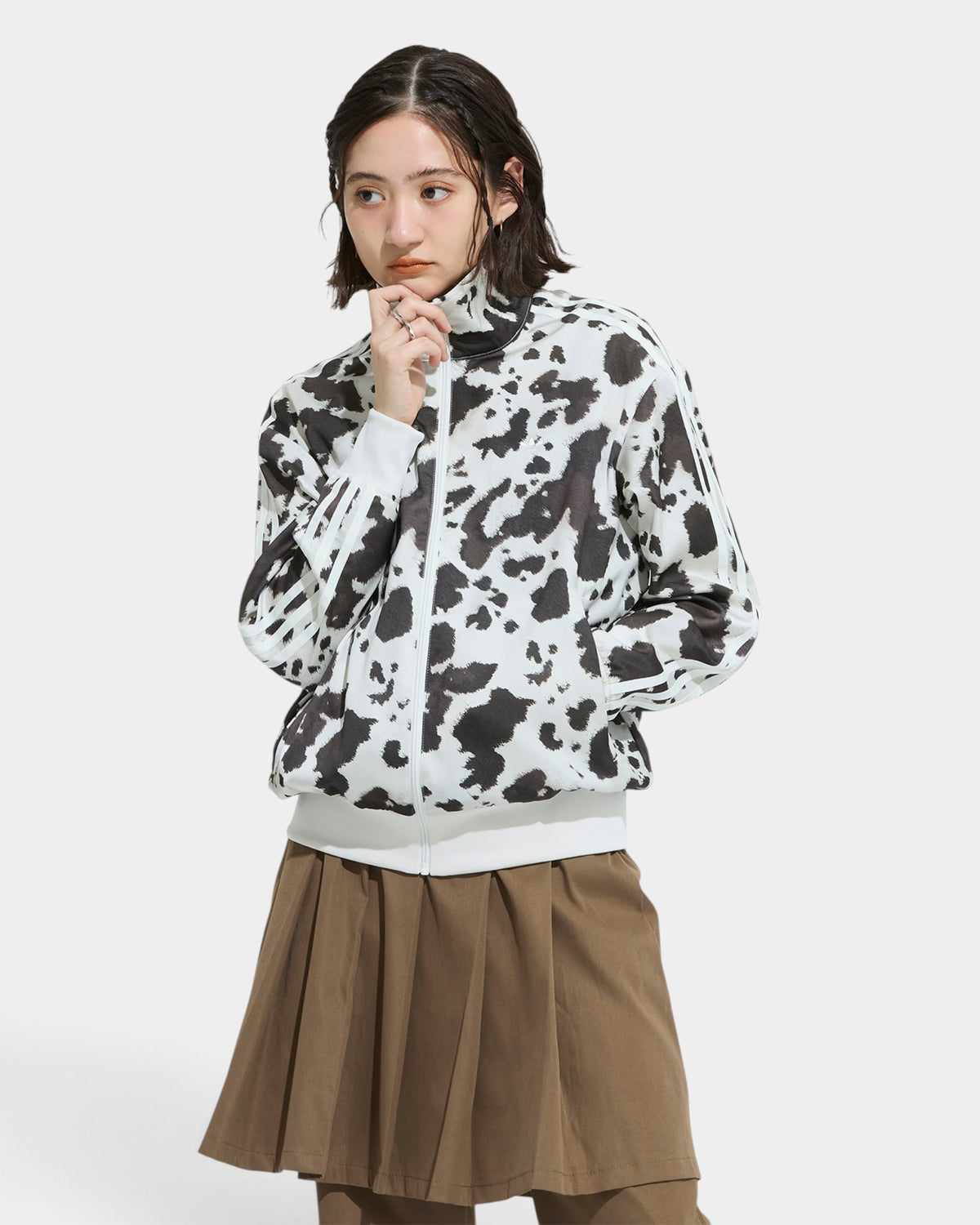 Lockwood Avenue model wearing an adidas satin track top with a black and white animal print and stand-up collar