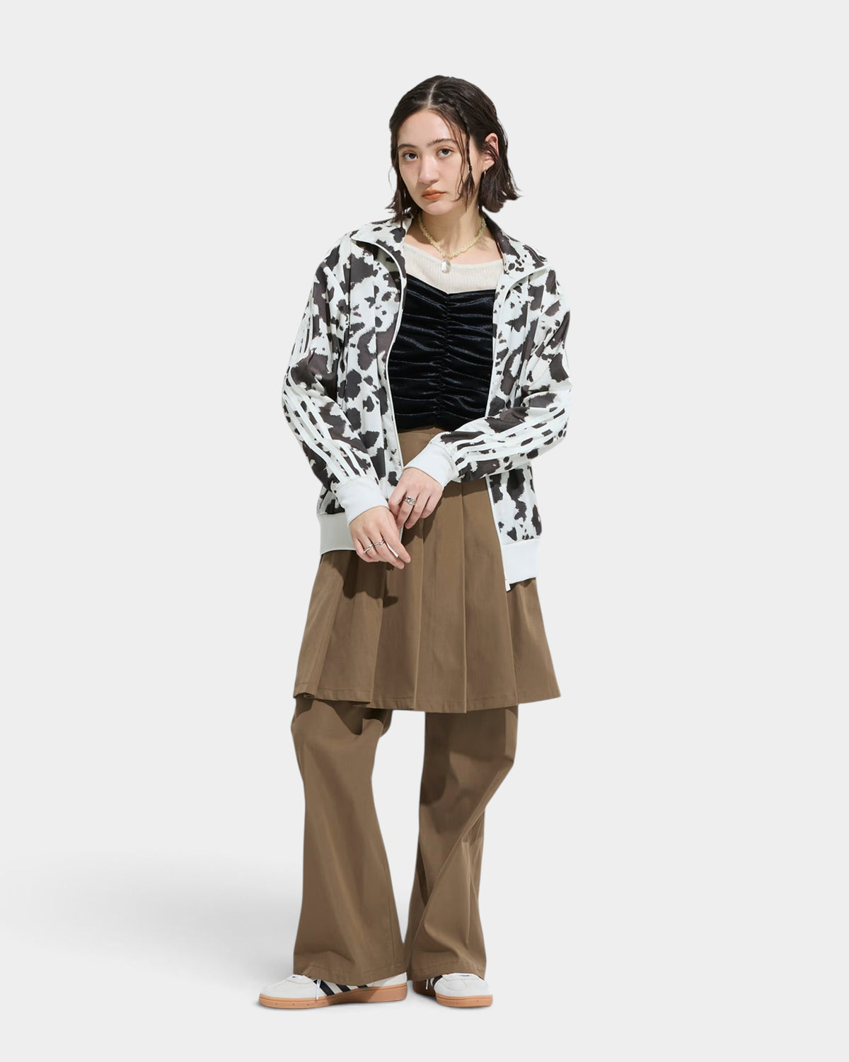 Lockwood Avenue model wearing an adidas satin animal print track top with a stand-up collar and 3-Stripes detailing.