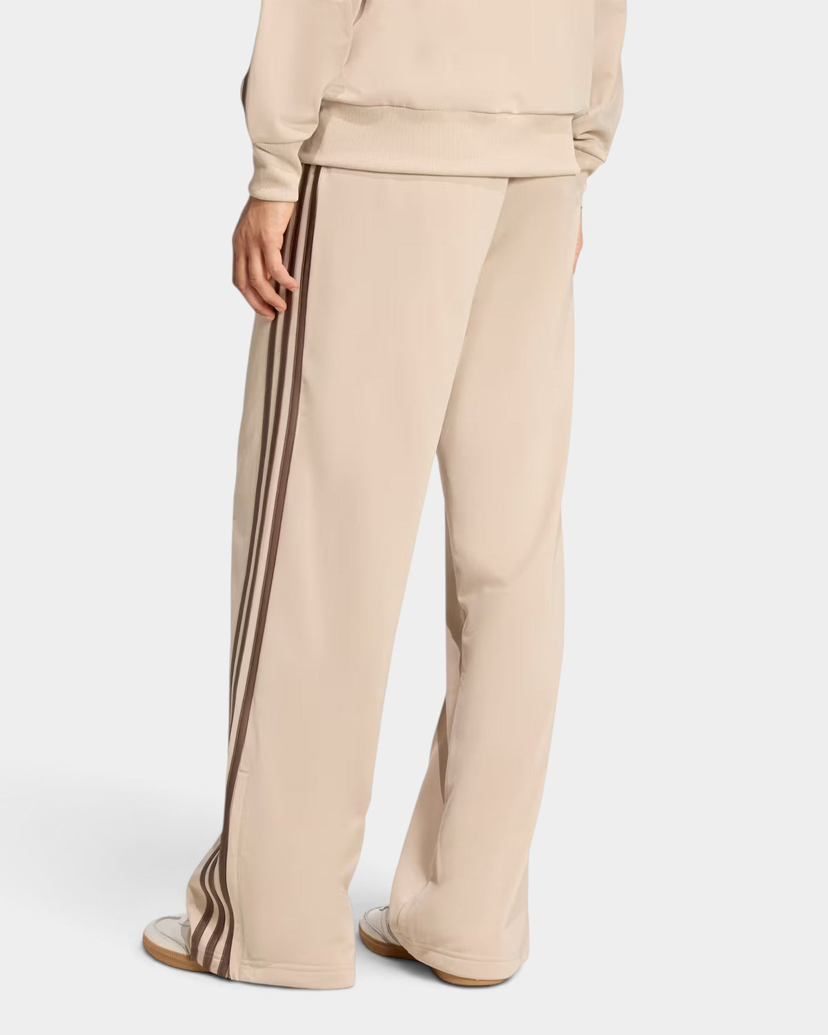 Lockwood Avenue adidas Firebird loose beige tricot track pants with brown 3-Stripes and ankle zips, rear view
