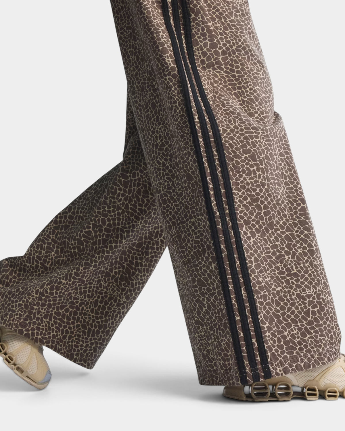 Lockwood Avenue adidas Firebird loose-fit denim pants in brown animal print with signature black side stripes