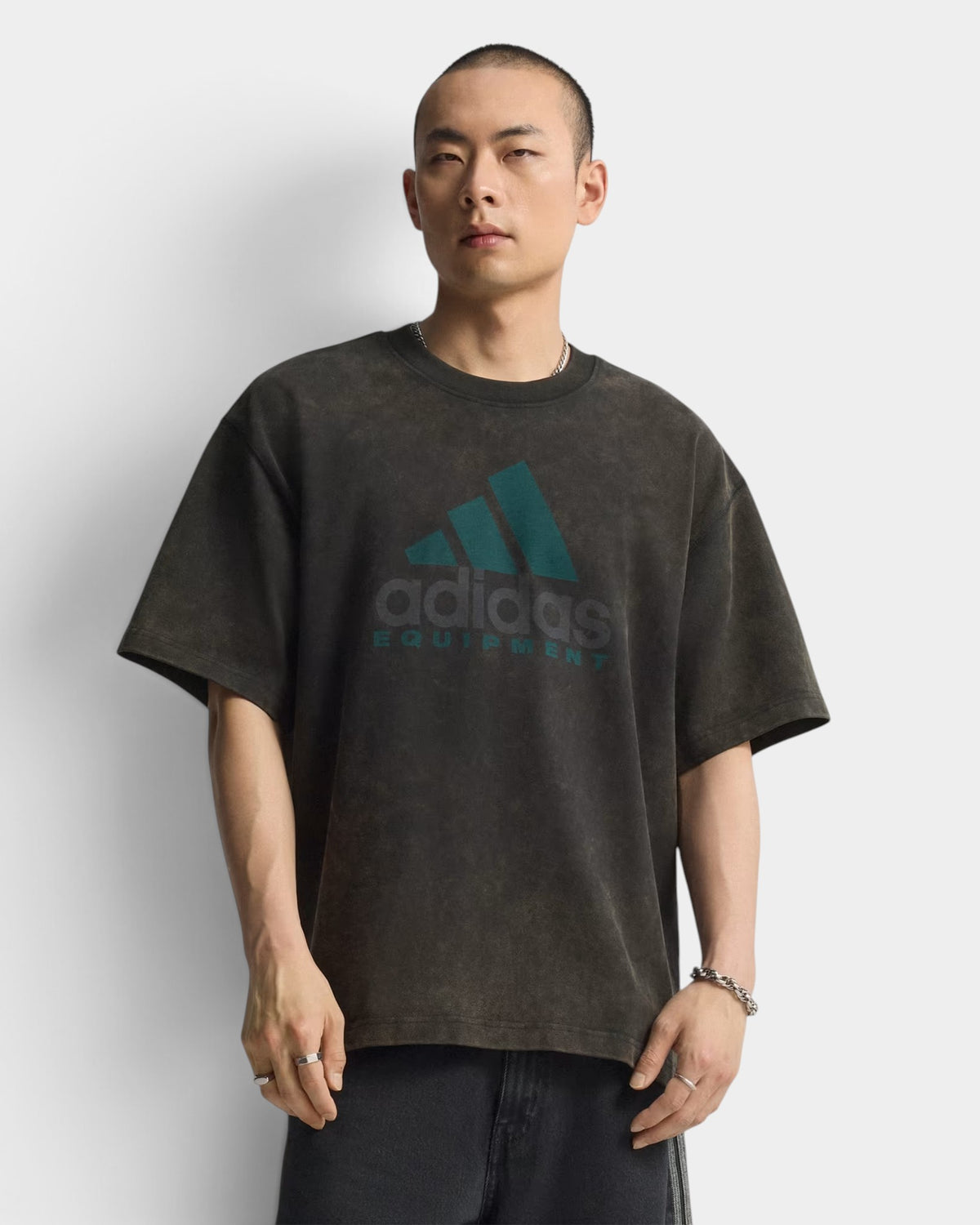 Lockwood Avenue model wearing an oversized black cotton adidas Equipment t-shirt with a vintage-style graphic print.