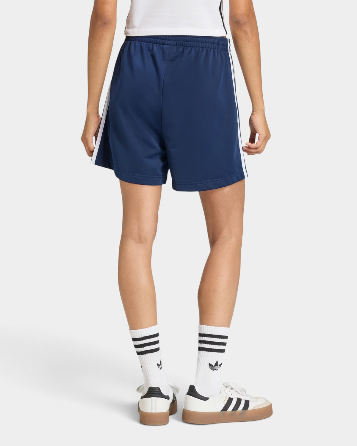 Lockwood Avenue adidas Firebird blue tricot shorts with white 3-Stripes, back view on model