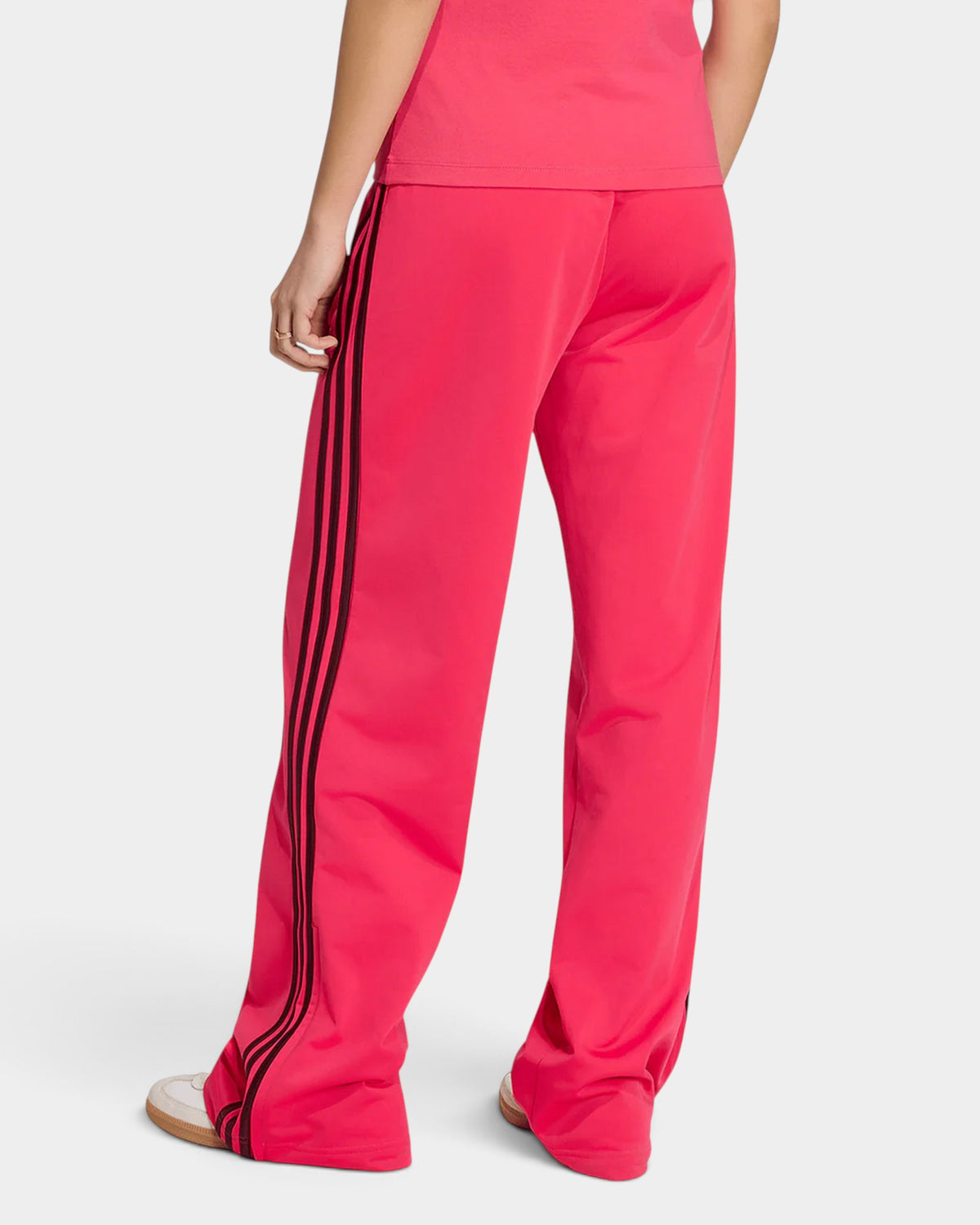 Lockwood Avenue adidas Adicolor Firebird loose track pants in pink with maroon 3-Stripes, back view on a model.