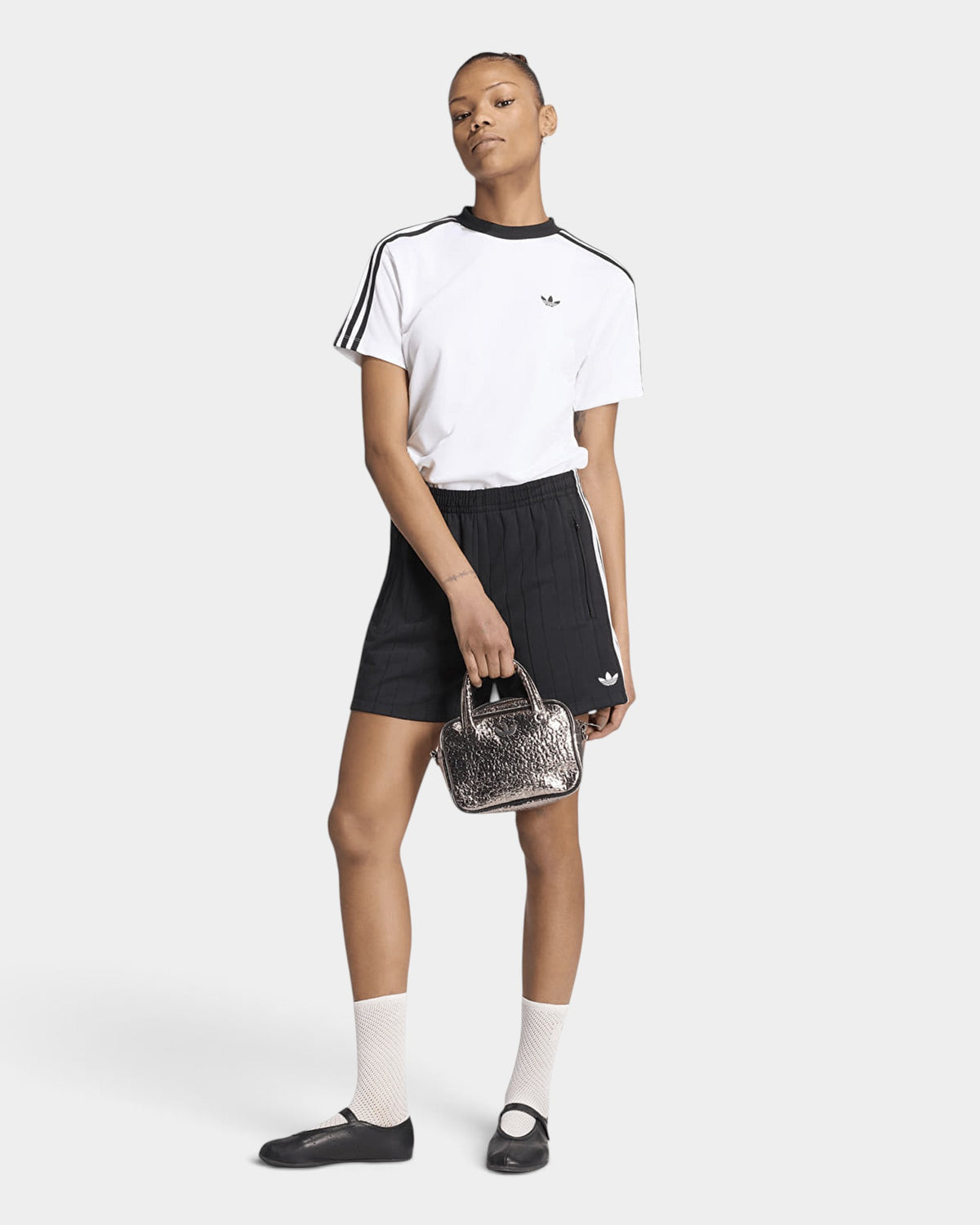 Lockwood Avenue model wearing adidas Pinstripe Sprinter Shorts in Black with a white tee and black flats, full length