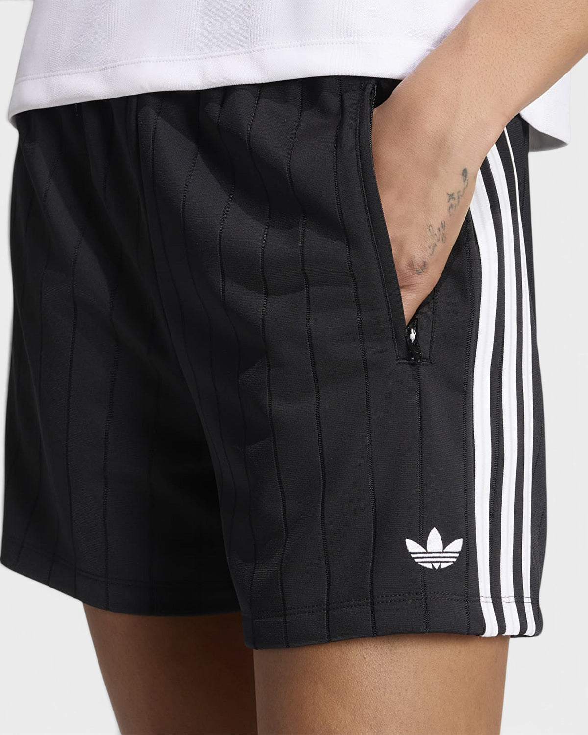 Lockwood Avenue close-up of the side zip pocket, tonal pinstripe and white 3-Stripes on adidas Pinstripe Sprinter Shorts in Black