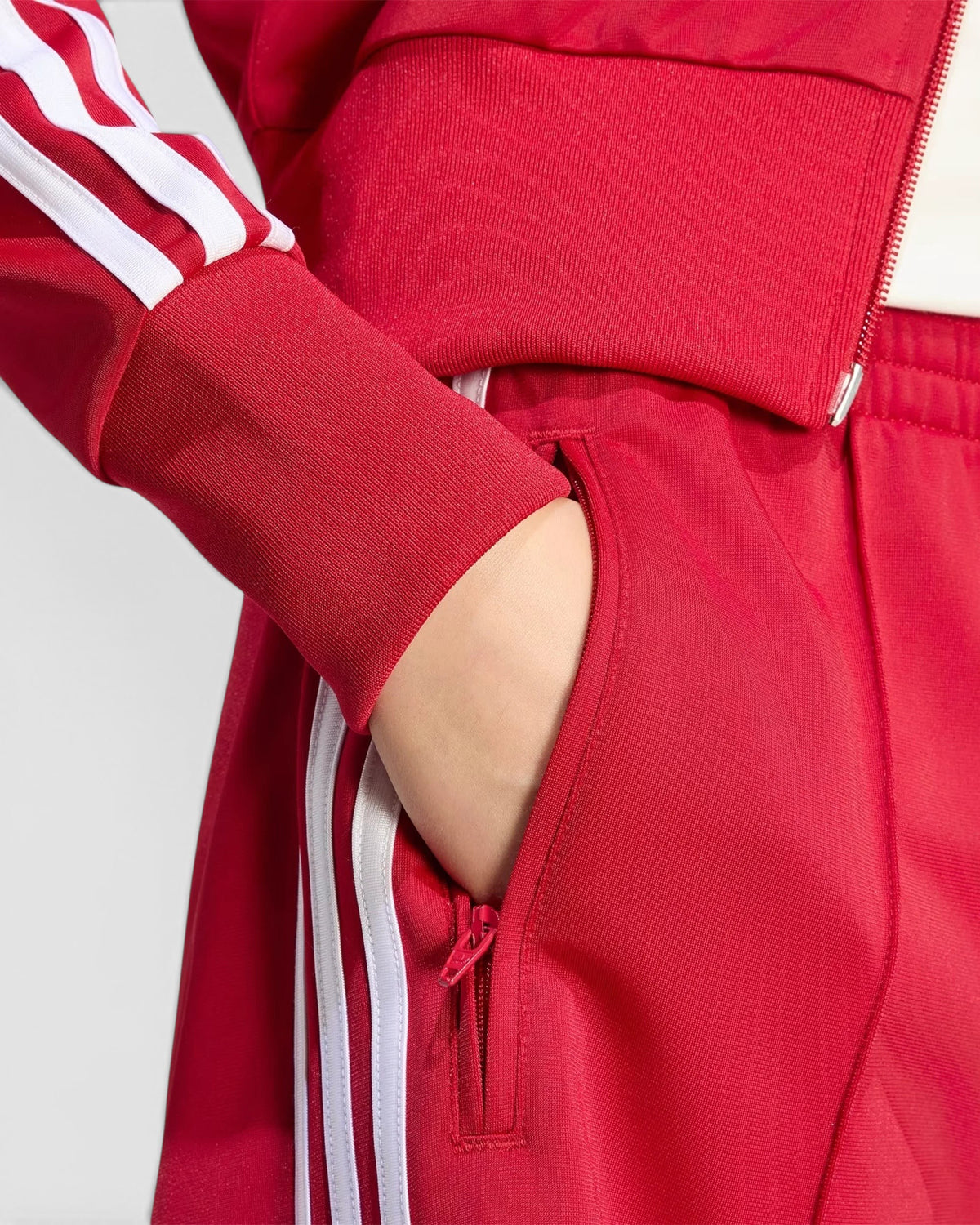 Lockwood Avenue adidas Firebird red tricot shorts featuring white 3-Stripes and a zippered side pocket