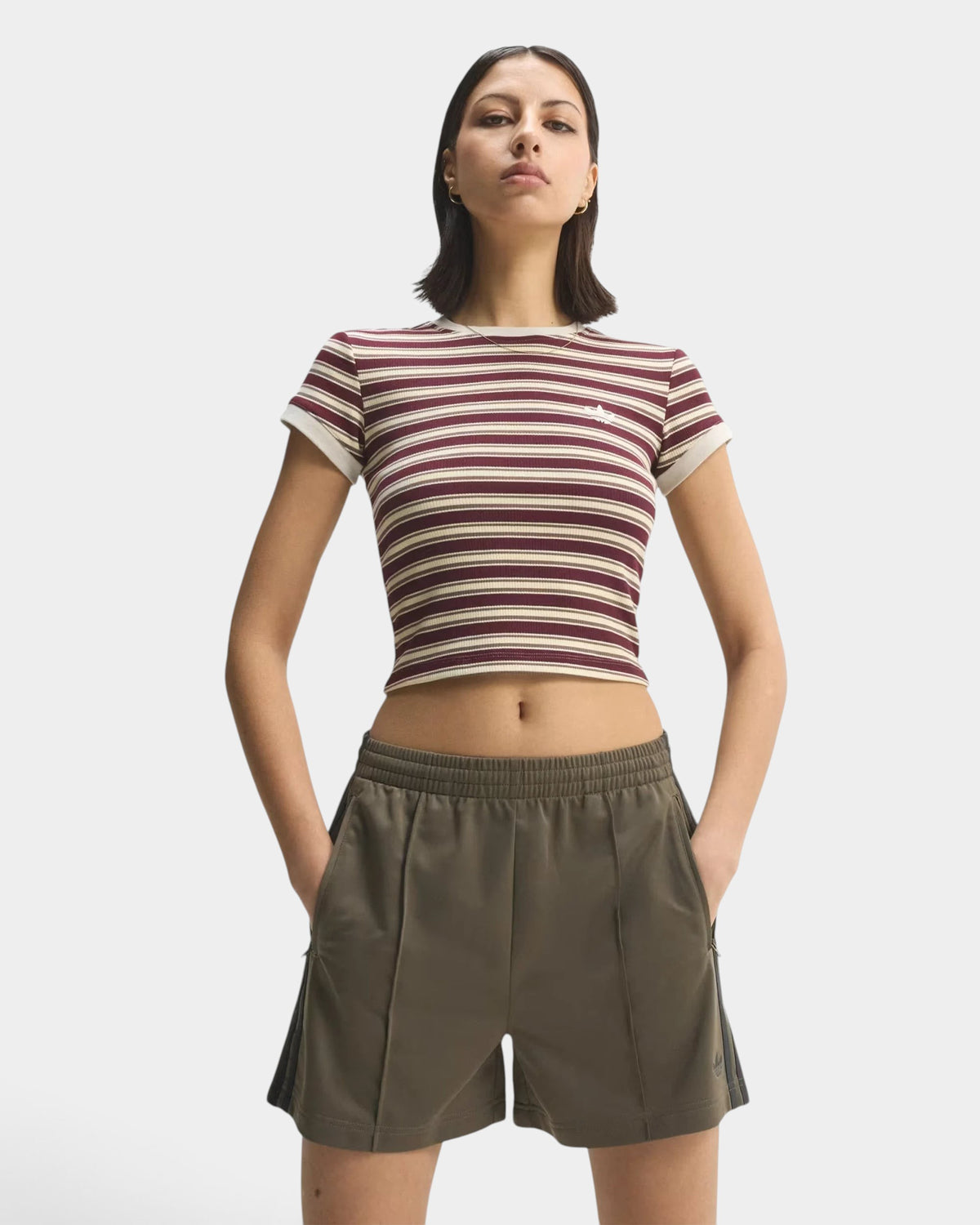 Lockwood Avenue model wearing olive green adidas Firebird Classic shorts with a mid-rise waist and loose fit