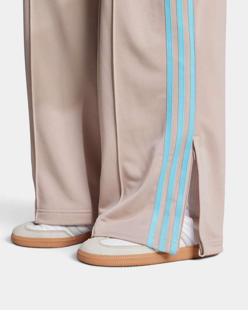 Lockwood Avenue adidas Adicolor Firebird loose track pants in taupe tricot with blue 3-Stripes and ankle zip detail.