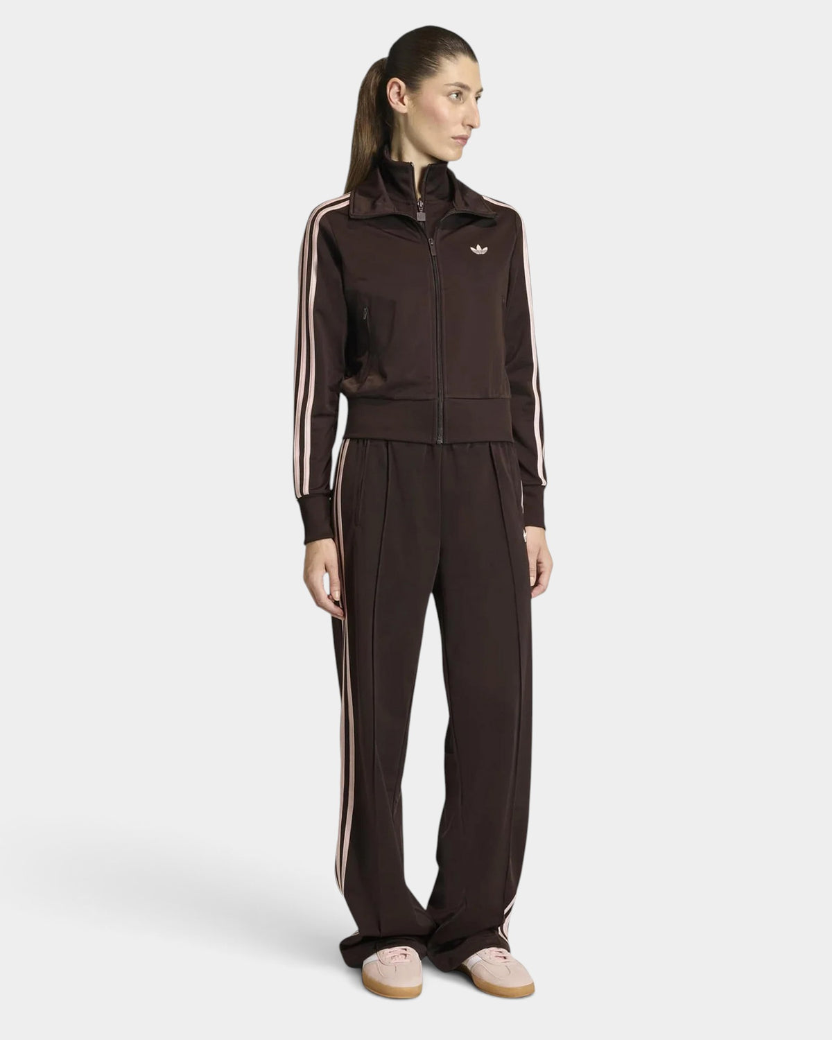 Lockwood Avenue model wearing an aurora coffee adidas Firebird track top and matching pants with sandy pink 3-Stripes.