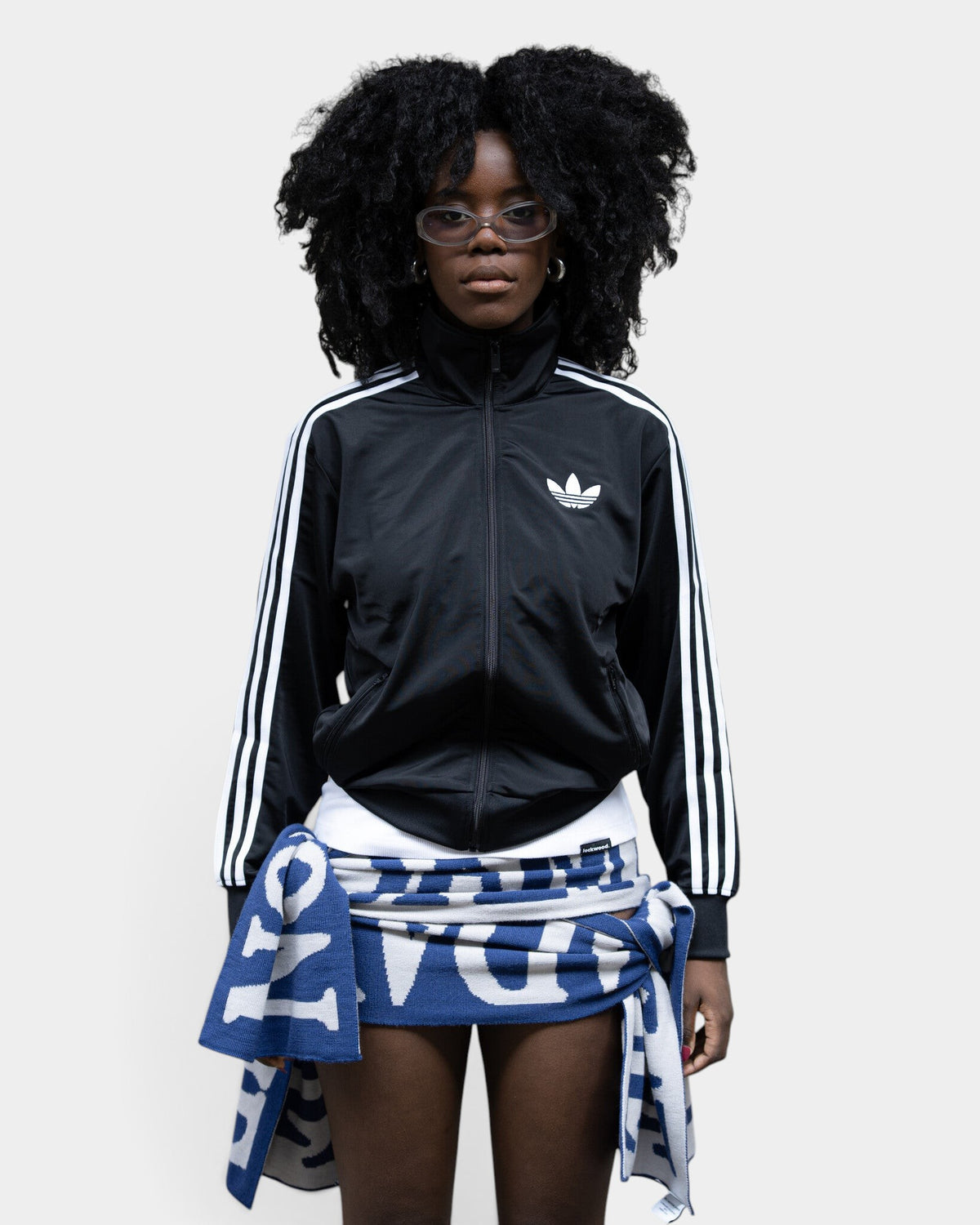 Lockwood Avenue model wearing a black adidas Adicolor Classic Firebird loose track top with white 3-Stripes