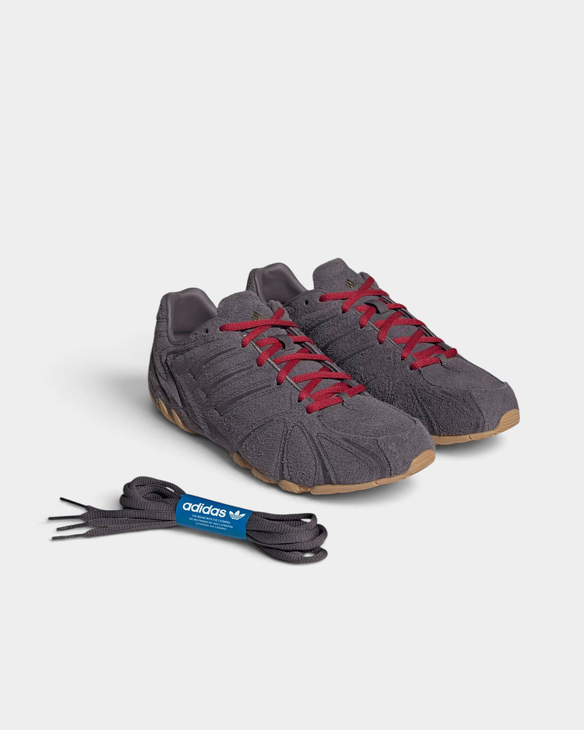 Lockwood Avenue adidas Ghost Sprint women's grey suede sneakers with red laces and low-profile gum rubber outsoles.