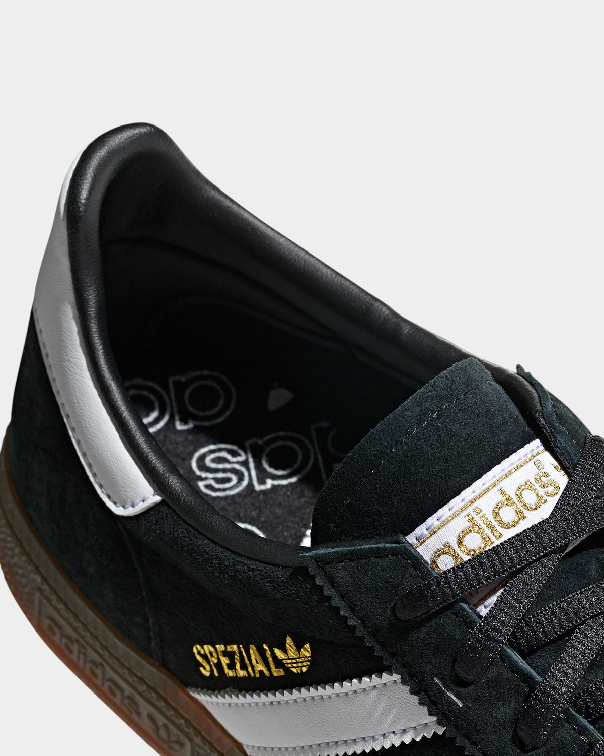 Lockwood Avenue adidas Handball Spezial black suede sneaker with gold branding, white heel tab, and gum rubber sole.
